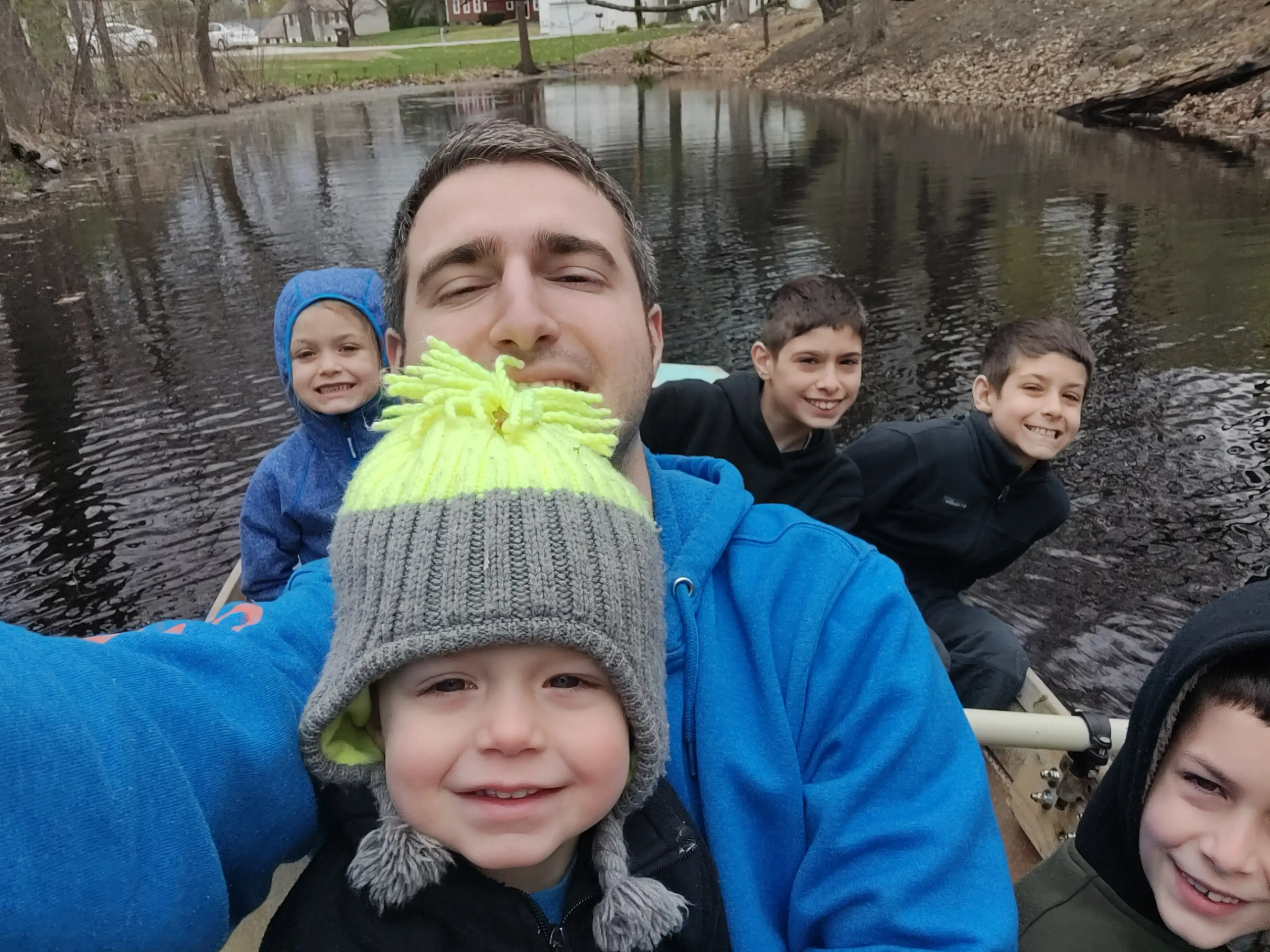 My brother, cousins and I on a boat in a pond.